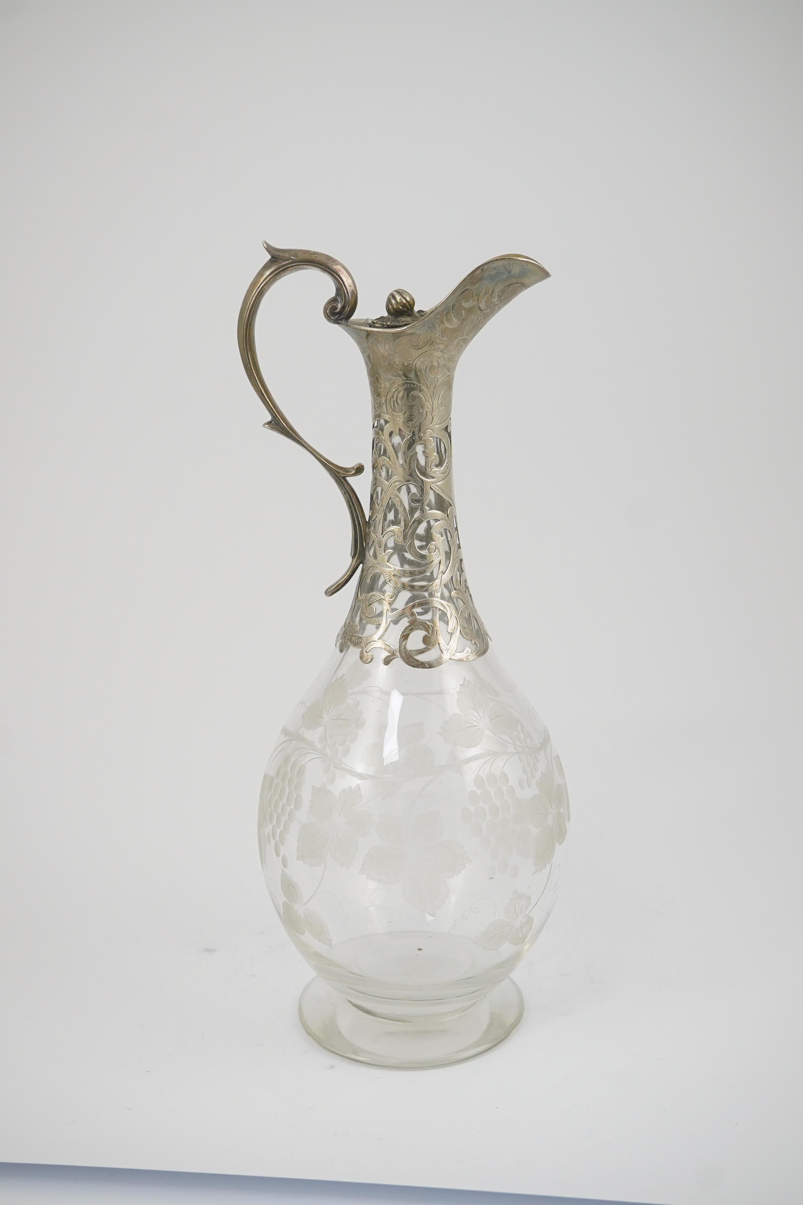 A Victorian parcel gilt silver mounted glass pyriform claret jug, by Joseph Angell II